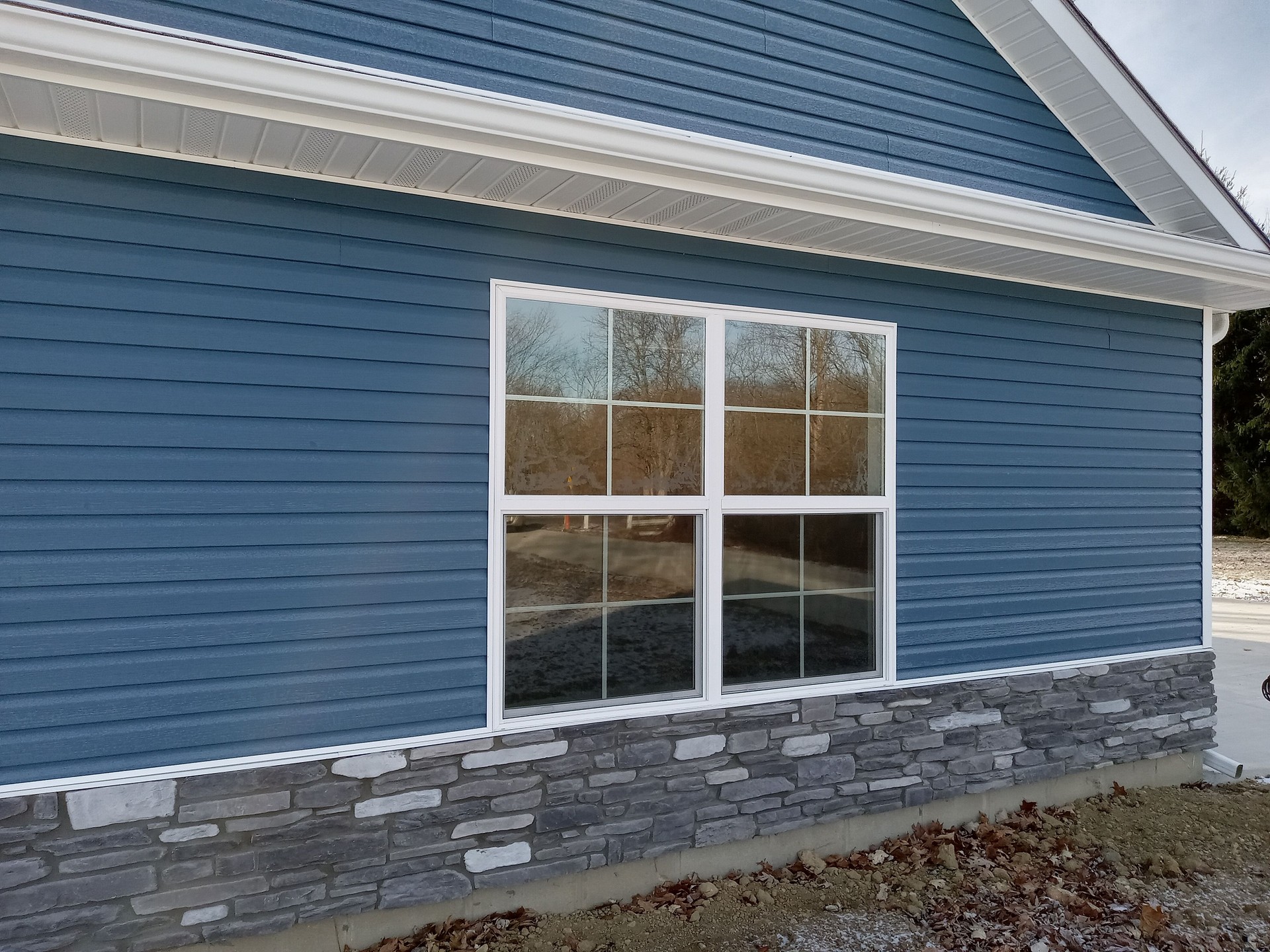 Blue vinyl siding and gutters